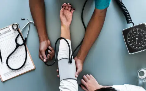 Lekarz mierzy ciśnienie. Podobnie jak w liście motywacyjnym, ważne są kluczowe dane i profesjonalizm.